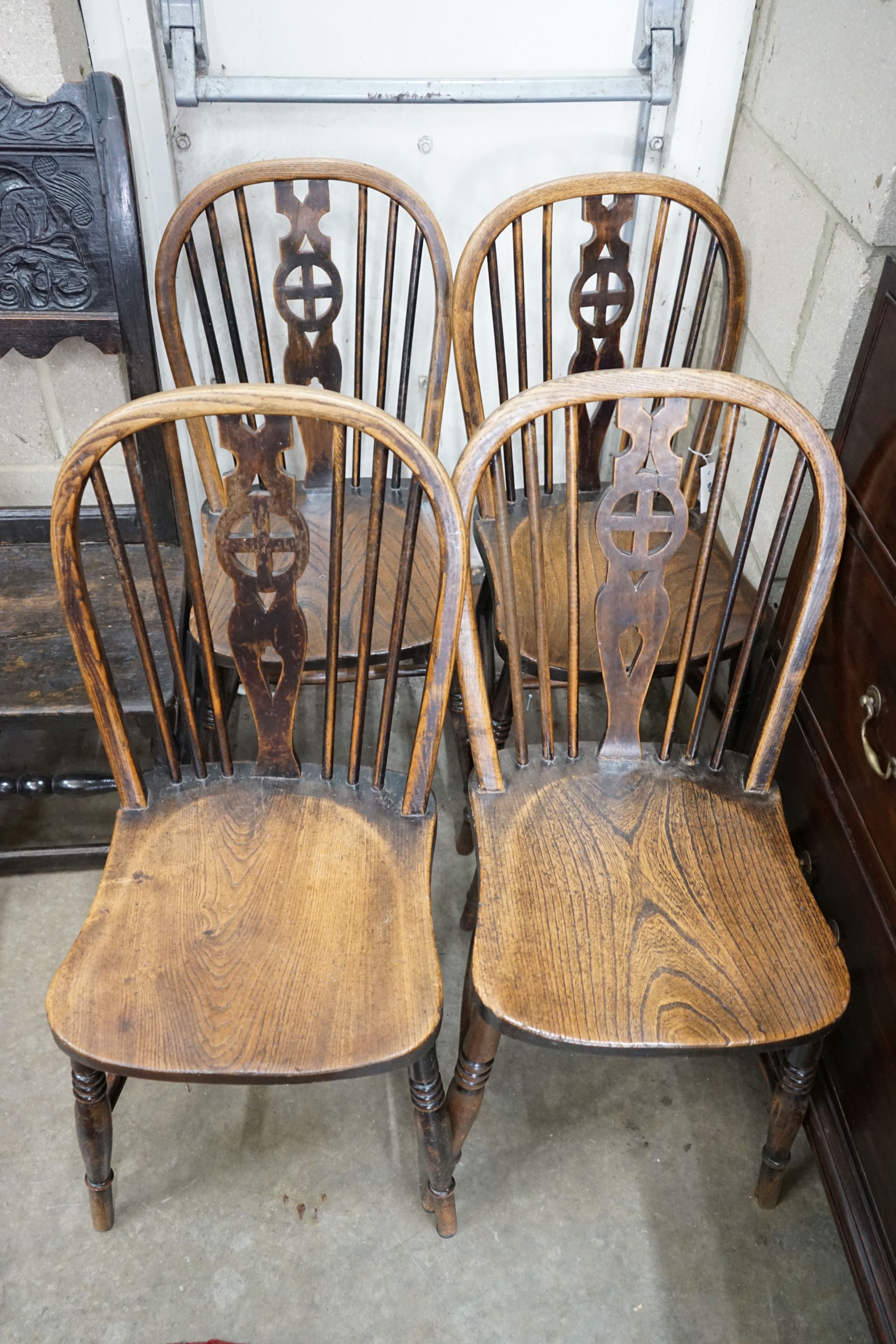 A set of four Victorian ash and elm Windsor wheelback dining chairs